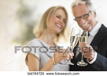 Smiling older Caucasian couple toasting with champagne View Large Photo Image Stock Photography - Smiling older Caucasian couple toasting with champagne. Fotosearch