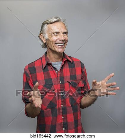 Stock Image - Smiling older Caucasian man gesturing. Fotosearch