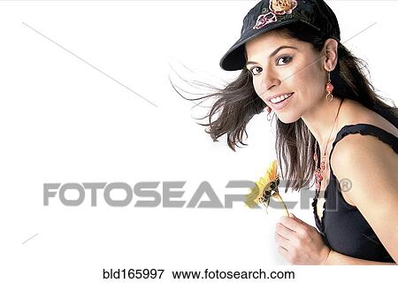 Stock Photo - Smiling woman holding flower. Fotosearch
