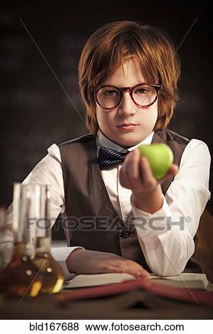 Student holding apple and studying View Large Photo Image Stock Photo - Student holding apple and studying. Fotosearch