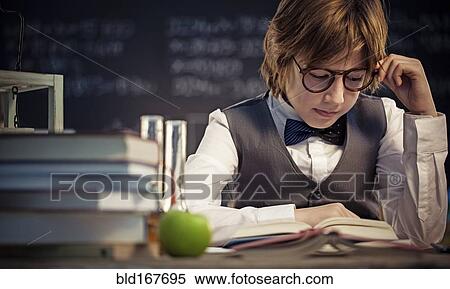 Student reading book at desk in classroom View Large Photo Image Stock Photography - Student reading book at desk in classroom. Fotosearch