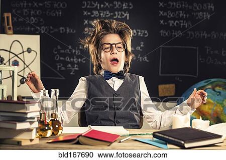 Stock Image - Student talking at desk in classroom. Fotosearch