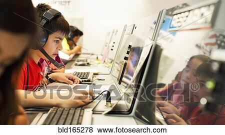 Students using computers at desk View Large Photo Image Stock Photo - Students using computers at desk. Fotosearch