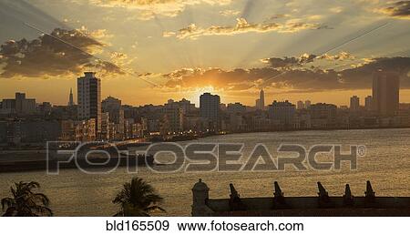 Sunset over high rise buildings in Havana cityscape, Havana, Cuba View Large Photo Image Stock Photo - Sunset over high rise buildings in Havana cityscape, Havana, Cuba. Fotosearch