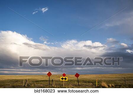 Traffic sign in remote field under clouds View Large Photo Image Stock Image - Traffic sign in remote field under clouds. Fotosearch