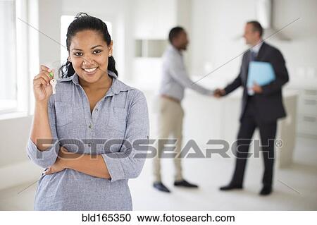 Woman holding keys in kitchen of new home View Large Photo Image Stock Image - Woman holding keys in kitchen of new home. Fotosearch