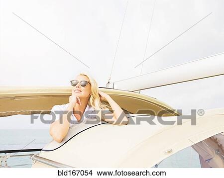 Picture - Woman in sunglasses sailing. Fotosearch