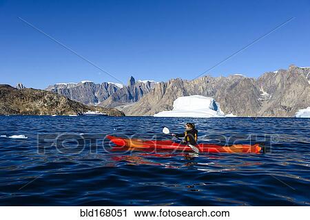 Woman paddling canoe near glaciers in remote river View Large Photo Image Stock Image - Woman paddling canoe near glaciers in remote river. Fotosearch