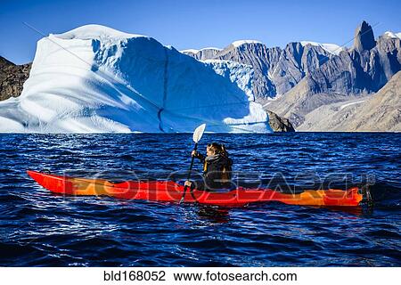 Woman paddling canoe near glaciers in remote river View Large Photo Image Stock Image - Woman paddling canoe near glaciers in remote river. Fotosearch