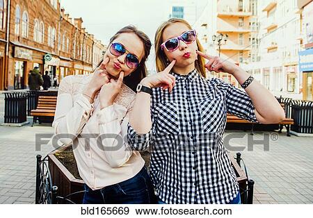 Stock Photo - Women making faces in city. Fotosearch