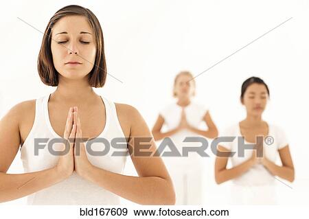 Women meditating in yoga class View Large Photo Image Stock Photo - Women meditating in yoga class. Fotosearch