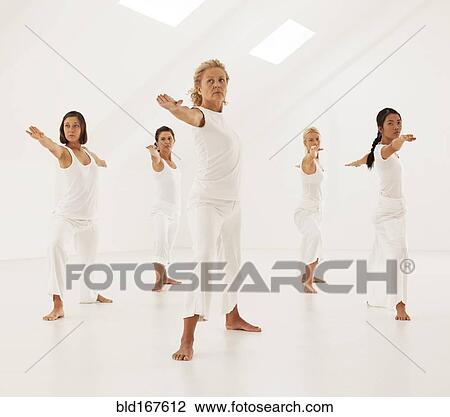 Women practicing yoga in class View Large Photo Image Stock Image - Women practicing yoga in class. Fotosearch