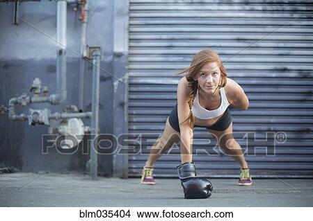 Picture - Boxer doing push-ups at warehouse. Fotosearch