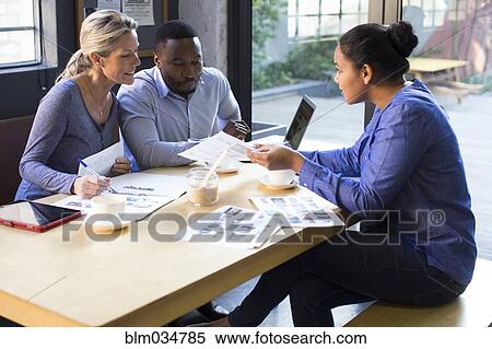 Stock Photography - Business people talking in office meeting. Fotosearch