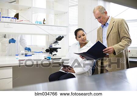 Stock Photograph - Businessman and scientist talking in laboratory. Fotosearch