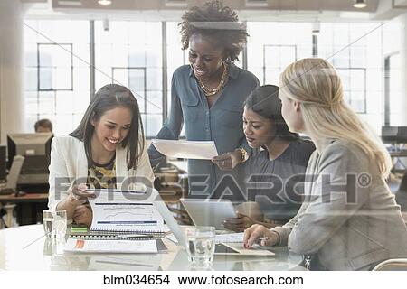 Businesswomen talking in office meeting View Large Photo Image Picture - Businesswomen talking in office meeting. Fotosearch