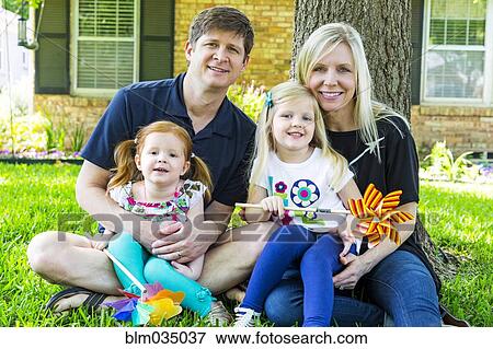 Stock Photo - Caucasian family smiling in backyard. Fotosearch