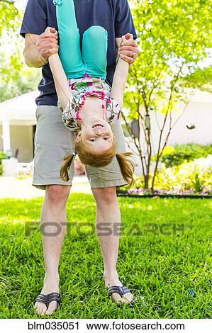 Caucasian father and daughter playing in backyard View Large Photo Image Stock Image - Caucasian father and daughter playing in backyard. Fotosearch