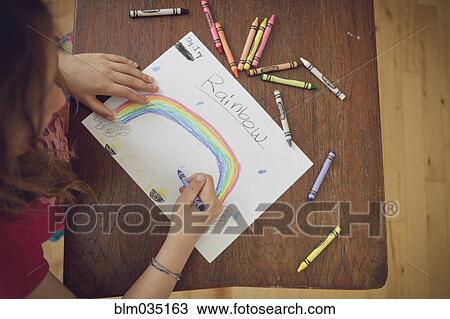Caucasian girl drawing rainbow with crayons on table View Large Photo Image Stock Image - Caucasian girl drawing rainbow with crayons on table. Fotosearch