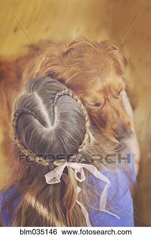 Stock Photograph - Caucasian girl hugging dog. Fotosearch