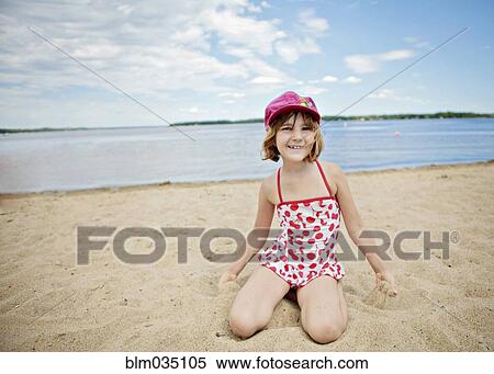Caucasian girl kneeling on beach View Large Photo Image Stock Photography - Caucasian girl kneeling on beach. Fotosearch