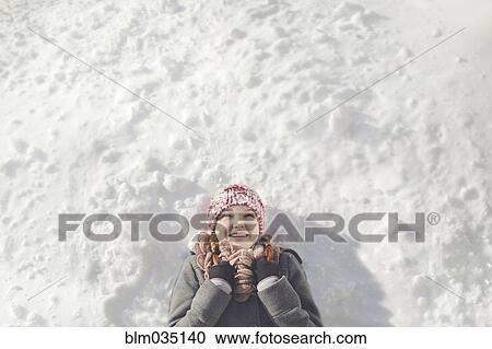 Caucasian girl laying in snow View Large Photo Image Stock Image - Caucasian girl laying in snow. Fotosearch