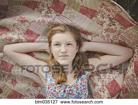 Caucasian girl laying on blanket View Large Photo Image Stock Photo - Caucasian girl laying on blanket. Fotosearch