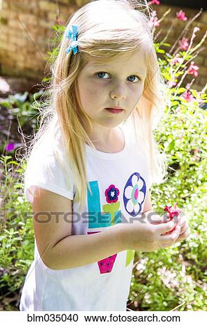 Caucasian girl playing in backyard View Large Photo Image Stock Image - Caucasian girl playing in backyard. Fotosearch