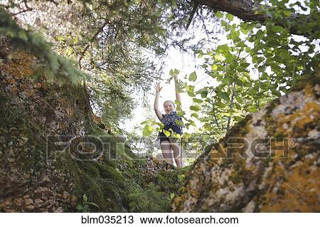 Caucasian girl playing in forest View Large Photo Image Stock Image - Caucasian girl playing in forest. Fotosearch