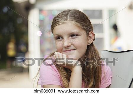 Caucasian girl resting chin in hand View Large Photo Image Stock Image - Caucasian girl resting chin in hand. Fotosearch