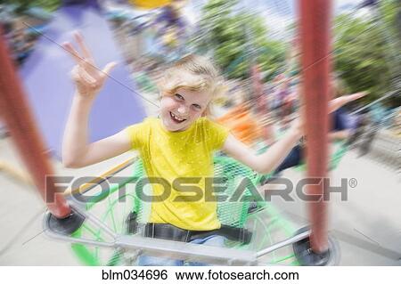 Caucasian girl riding roller coaster in amusement park View Large Photo Image Stock Photograph - Caucasian girl riding roller coaster in amusement park. Fotosearch