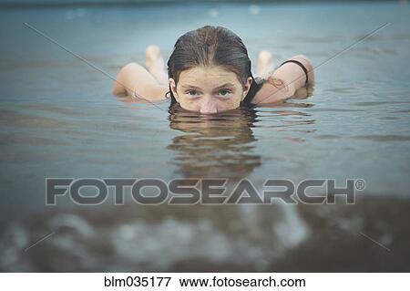 Caucasian girl swimming View Large Photo Image Stock Photo - Caucasian girl swimming. Fotosearch
