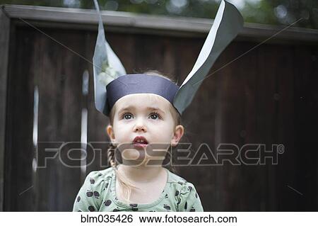 Caucasian girl wearing paper hat in backyard View Large Photo Image Stock Photograph - Caucasian girl wearing paper hat in backyard. Fotosearch