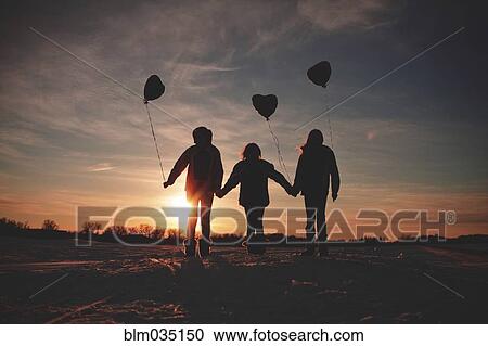 Caucasian girls walking with balloons at sunset View Large Photo Image Stock Image - Caucasian girls walking with balloons at sunset. Fotosearch