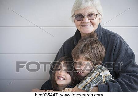 Caucasian grandmother and grandchildren smiling outdoors View Large Photo Image Stock Photo - Caucasian grandmother and grandchildren smiling outdoors. Fotosearch