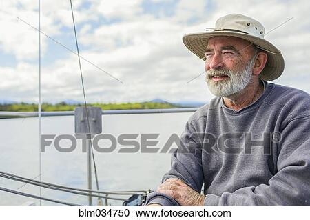 Caucasian man sailing on boat View Large Photo Image Stock Image - Caucasian man sailing on boat. Fotosearch