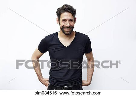 Stock Photograph - Caucasian man standing with hands on hips. Fotosearch