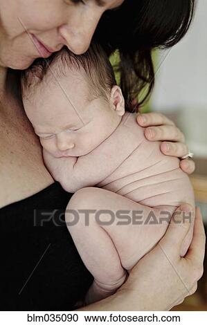Caucasian mother holding newborn baby View Large Photo Image Stock Image - Caucasian mother holding newborn baby. Fotosearch