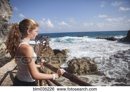 Stock Photograph - Caucasian teenage girl enjoying ocean view. Fotosearch