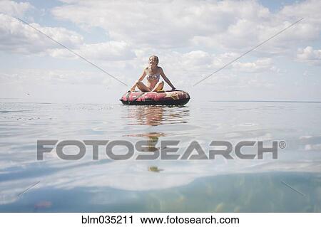 Caucasian teenage girl floating in inner tube on lake View Large Photo Image Stock Image - Caucasian teenage girl floating in inner tube on lake. Fotosearch