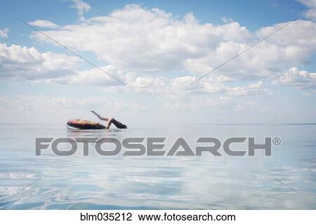 Caucasian teenage girl jumping from inner tube into lake View Large Photo Image Stock Image - Caucasian teenage girl jumping from inner tube into lake. Fotosearch