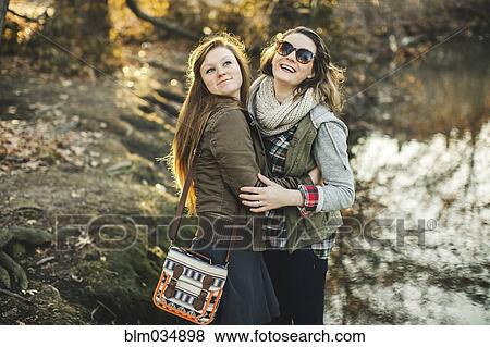 Stock Photo - Caucasian woman hugging in park. Fotosearch