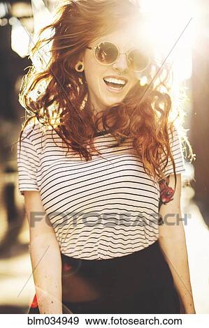 Stock Photo - Caucasian woman jumping for joy outdoors. Fotosearch