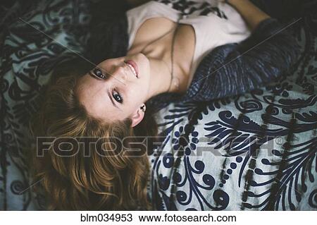 Caucasian woman laying on bed View Large Photo Image Stock Image - Caucasian woman laying on bed. Fotosearch
