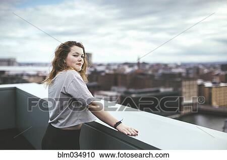 Caucasian woman on urban rooftop admiring cityscape View Large Photo Image Stock Image - Caucasian woman on urban rooftop admiring cityscape. Fotosearch