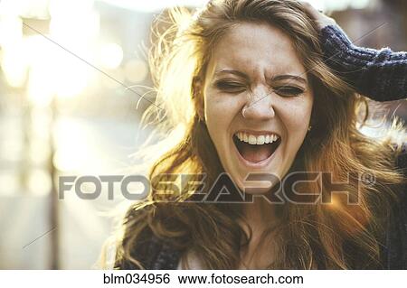 Stock Photograph - Caucasian woman shouting outdoors. Fotosearch