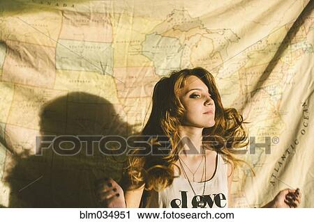 Stock Image - Caucasian woman standing in front of fabric map. Fotosearch