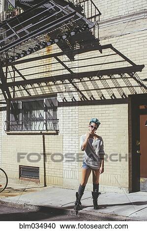 Caucasian woman standing on city sidewalk View Large Photo Image Stock Image - Caucasian woman standing on city sidewalk. Fotosearch