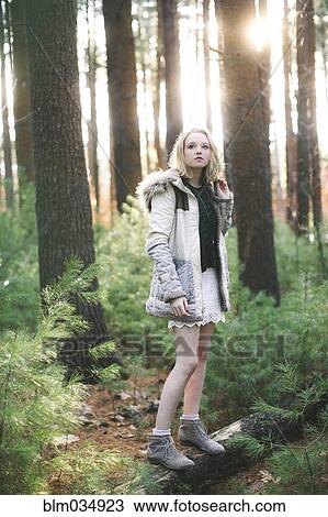 Caucasian woman standing on tree log in forest View Large Photo Image Stock Image - Caucasian woman standing on tree log in forest. Fotosearch