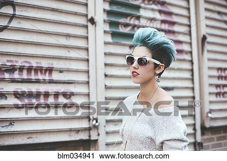 Stock Image - Caucasian woman walking at warehouse. Fotosearch